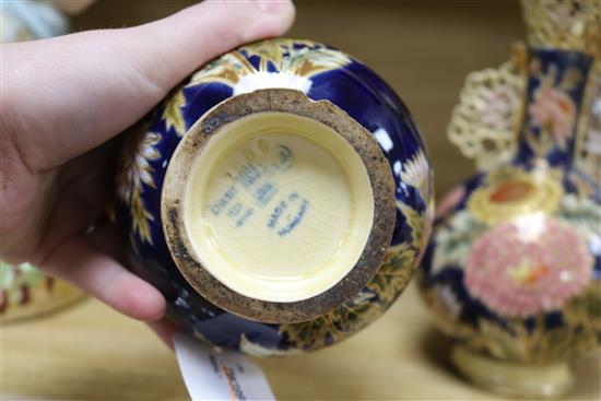 A pair of Zsolnay Pecs reticulated vases, floral-decorated on a blue ground and heightened in gilt height 20cm (a.f.)